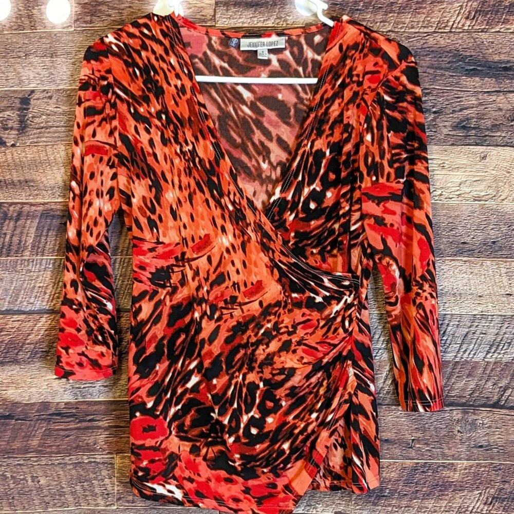 Jennifer Lopez small orange and black animal print top. fall/winter resort wear